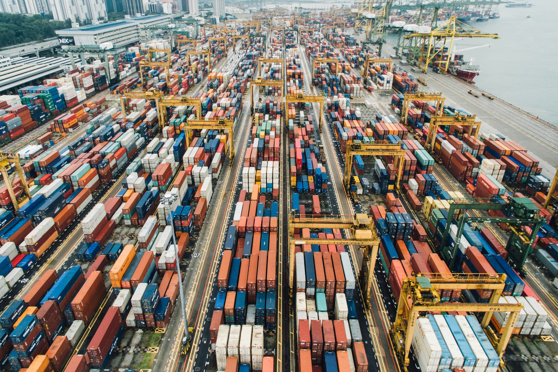 Cargo ship loaded with shipping containers at a port — global castor oil distribution